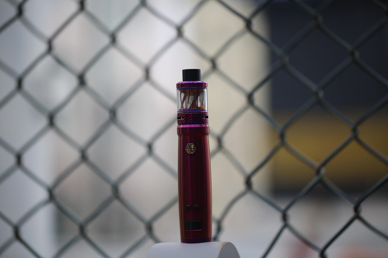 Rows of e-liquid bottles in assorted fruit and mint flavors on shelves